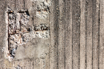 Broken concrete wall with details of ferroconcrete structure as reinforced concrete with metal skeleton shows damages and ailing and aging concrete wall or bunker protection in war time after attacks