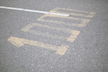 Fototapeta premium Directional marking on asphalt road, showing 'LEFT' with arrow pointing left