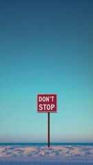 Red sign with Don't Stop text against blue background, concept of motivation