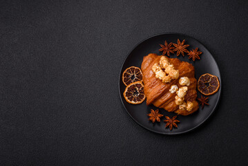 Sweet crispy croissant with salted caramel and glazed popcorn
