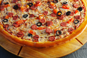 Freshly baked pepperoni pizza, generously layered with olives and tomatoes, emerges golden and crispy, inviting everyone to indulge in a delightful culinary experience.