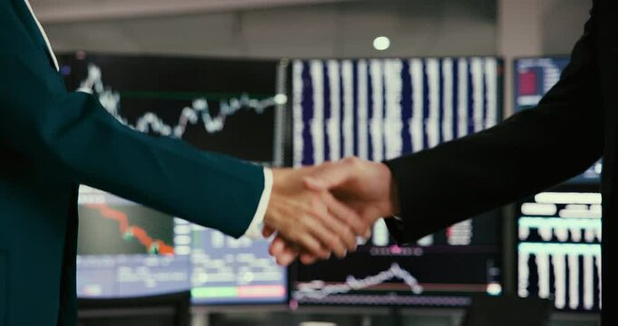 Business, people and handshake with computer screen for stock market, trading negotiation or finance promotion. Staff, meeting and deal with onboarding welcome, investment b2b and partnership support