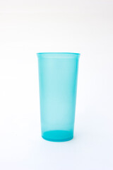 A bright blue plastic glass, perfect for outdoor picnics, barbecues, or beach outings, representing the joy of summer.