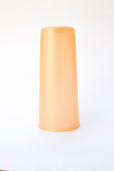 A sturdy pink plastic glass, perfect for children’s use, symbolizing safety and durability.