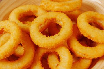 Golden rings of joy piled high, inviting taste buds with their crispy, fried perfection