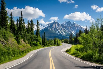 Winding mountain road with snow capped peaks in the background