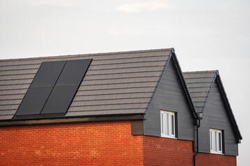 Photovoltaic solar panels on the roof of new built house in england uk. The concept of a sustainable environment, construction.