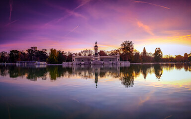 The Retiro Lake at dawn with a purple sky, an artificial body of water located in the Retiro Park...