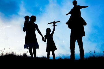 happy family by the sea on nature silhouette background