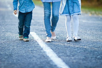 A Happy parent with child are walking along the road in the park on nature travel