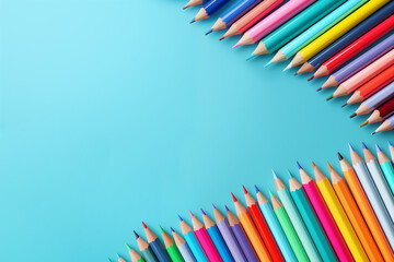 Fototapeta premium A colorful array of colored pencils is neatly arranged on a light blue background, ready for creative use. Light blue background