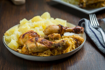 homemade dinner - baked chicken drumsticks with cabbage and potatoes