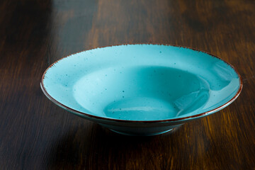 green stone plate on a wooden table