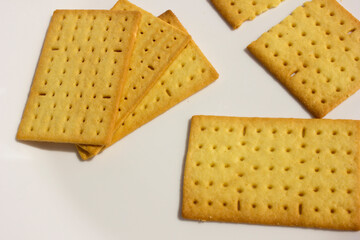 Squared salty cheese biscuits displayed on the white plate background, ready to accompany your favorite coffee or tea.