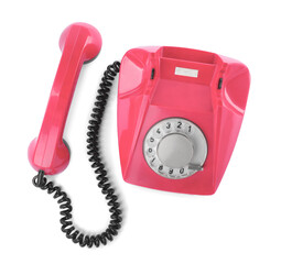 Old pink telephone with rotary dial isolated on white, top view