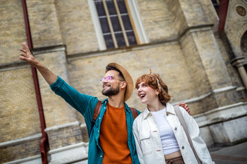 Couple exploring the city. Boyfriend showing his girlfriend