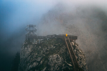 Fototapeta premium Valla Canyon. Magnificent Valla Canyon in the mist. The man in the yellow coat is climbing the canyon stairs. Kastamonu, Turkey.