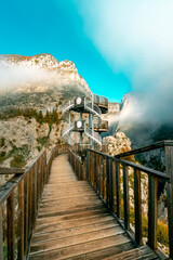 Fototapeta premium Valla Canyon located between the mountains. Magnificent Valla Canyon with fog and autumn trees.