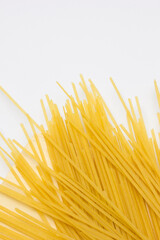 Dried fettuccine pasta on the white background. Dried fettuccine is a classic Italian pasta known for its flat, ribbon-like shape. It&rsquo;s a staple in many traditional Italian dishes.