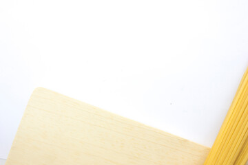 Raw fettuccine pasta isolated on the white background. Traditional fettuccine recipes often include eggs in the dough. This gives the pasta a delightful richness and golden color.