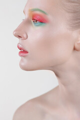 Fashion portrait of young beautiful woman with perfect skin and colorful makeup