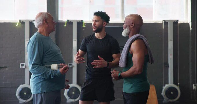 Mature man, personal trainer and friends in gym for exercise, workout or training. Physical therapy, elderly support and help with routine with fitness, discussion and wellness for retirement health