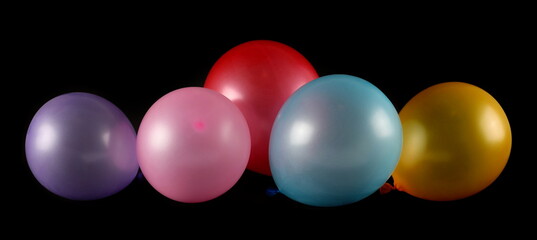 Colorful balloons isolated on black background