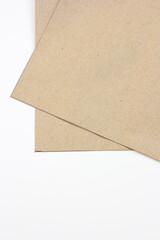 The clean lines of white paper intersect with the raw edges of kraft, making it ideal for showcasing handmade crafts or artisanal products.