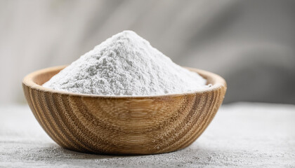 White zinc oxide powder in small wooden bowl. Healthcare and medical supplement product.