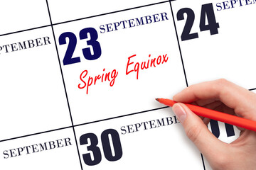 September 23. Hand writing text Spring Equinox on calendar date. Save the date.