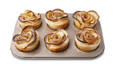 Freshly baked apple roses in cupcake pan isolated on white. Puff pastry