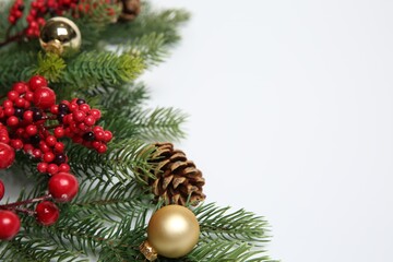 Fir tree branches with Christmas decor on white background, closeup. Space for text
