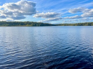 beautiful blue lake view, blue sky with white clouds reflections on the lake surface