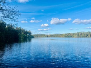 beautiful blue lake view, blue sky with white clouds reflections on the lake surface