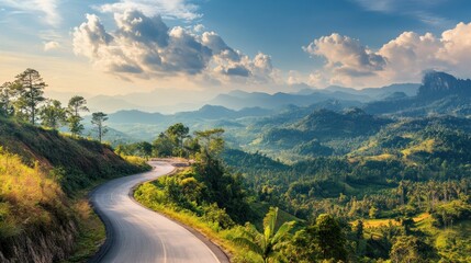 Obraz premium Winding Road Through Lush Green Mountains at Sunset