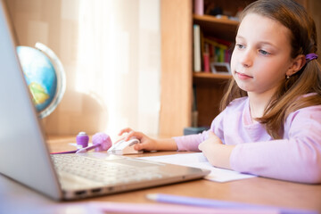 Pretty stylish schoolgirl studying homework math during her online lesson at home, social distance during quarantine,online education concept, home schooler.Online Lesson.