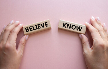 Believe or Know symbol. Concept word Believe or Know on wooden blocks. Businessman hand. Beautiful pink background. Business and Believe or Know concept. Copy space