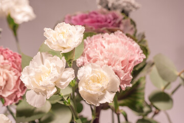 Beautiful bouquet of pink, grey and white carnation flowers, fresh eucalyptusas and violet brassica flower.
