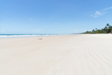 A tourist is seen having fun in the strong sun, on the sand of a beach in the city of Itacare, Bahia.