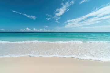 Fototapeta premium A serene beach with soft white sand and gentle waves under a clear blue sky, inviting relaxation and tranquility during a sunny day
