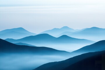 Beautiful gradient silhouette of mountains at dawn with vibrant tones of blue and soft pink hues blending into the sky above