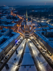 St Joseph church on snowy Rynek Podgorski square, Krakow, Poland, aerial view in the winter night