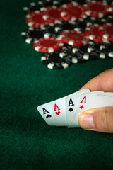 Poker cards with combinations of four of a kind or quads in the hand of a player. Winning combination in a game in a poker club on a green table. The concept of luck or fortune in gambling