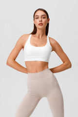 Fitness woman. Athletic girl on the gray background