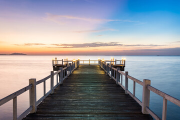  wooden bridge with sunset on the sea