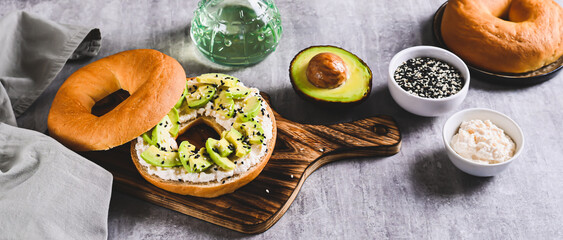 Delicious ricotta and avocado bagel on a breakfast board web banner