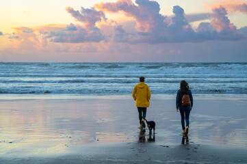 couple walking at sunset in the autumn in the beach in basque country