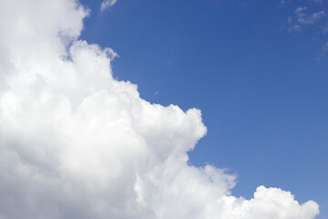 blue sky with fluffy warm clouds