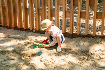Child on playground in summer park. High quality photo