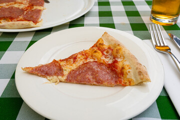 Pepperoni Pizza on Restaurant Plate, Salami Pizza with Olives, Tomatoes and Mozzarella Cheese